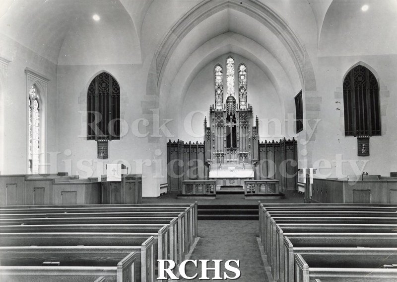Black and white photograph of the interior of Immanuel Lutheran Church, Red Wing, MN, looking toward the altar from behind the pews.