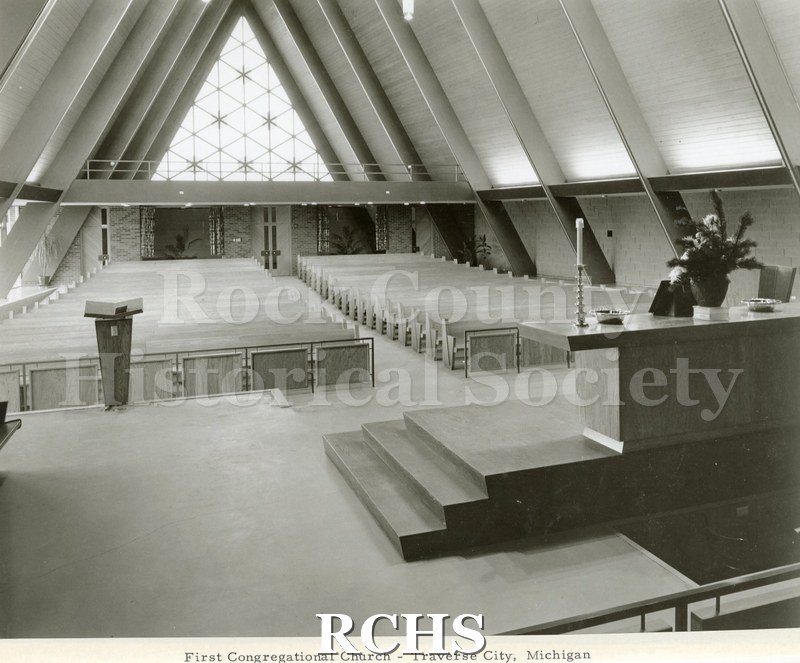 Black and white photograph of the interior of First Congregational Church, Traverse City, MI, looking toward the altar.