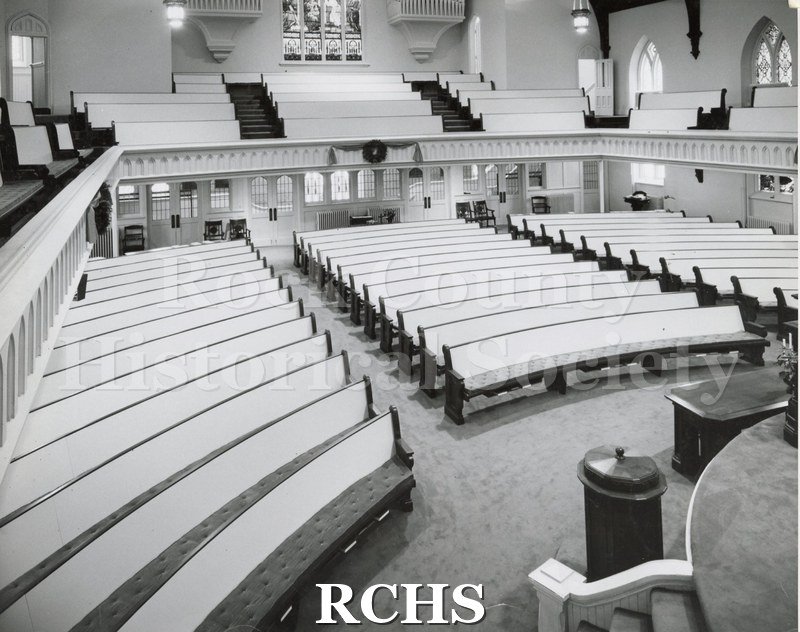Black and white photograph of the interior of First Congregational Church, Janesville, WI, looking toward the back.