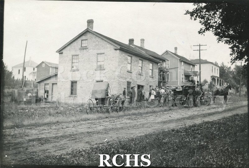 Black and white photograph of 618 S. Linn St., Janesville, WI. Shows a crowd scene.
