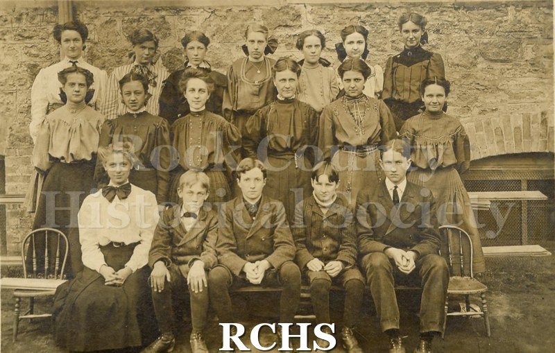 Historic image of Adams School Eight Grade Children 1906. Shows 18 young school students posed in a classroom. 1906..