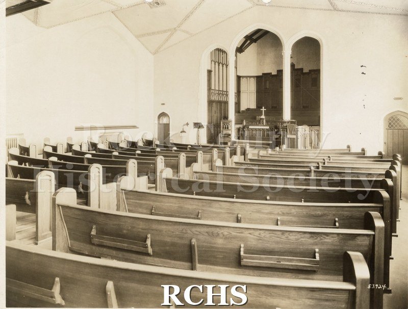 Black and white photograph of the interior of Bethel Ev. Church, Milwaukee, WI, showing pews leading up to the altar. The altar is in a vaulted area.