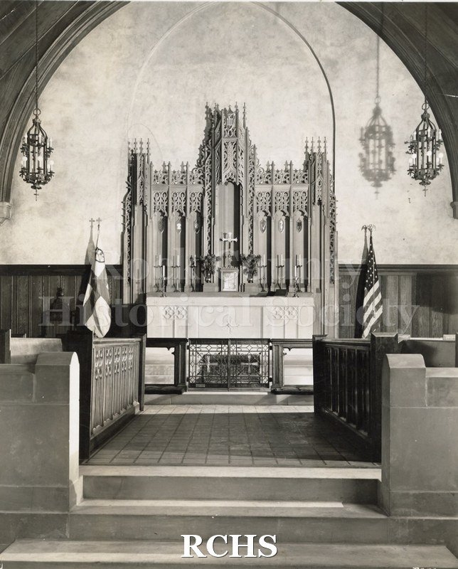 Black and white photograph of the interior of Church of the Advent, Chicago, IL, showing the altar area with an elaborate reredo behind the altar.