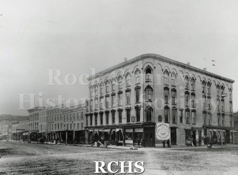 Black and white photograph of Lappin's Block. Shows a four story building witha sign: "Webb & Hall" "Jewelry and Silverware" on the side.