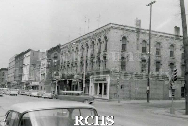 Black and white photograph of a portion of the buildings on Main Street.