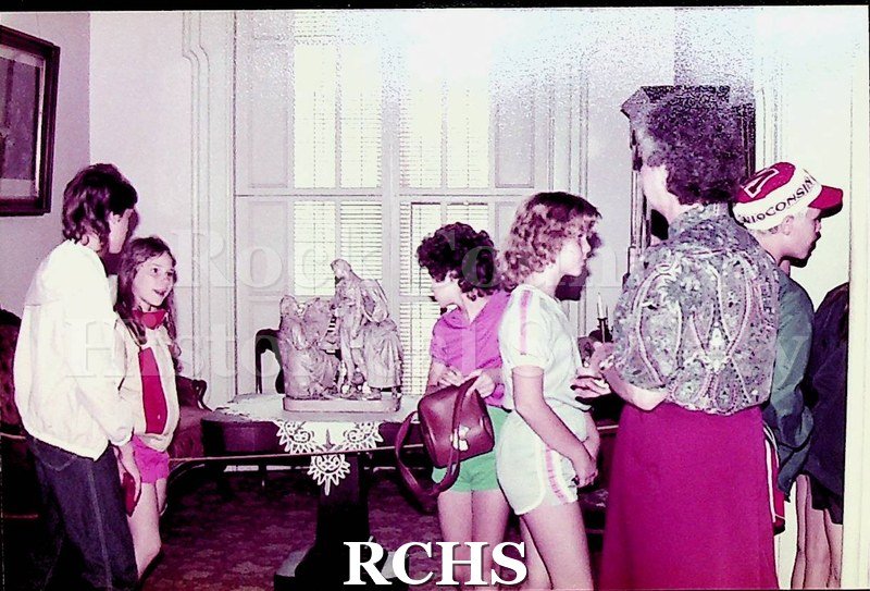 Colored photograph of unidentified school children visiting the Tallman House.