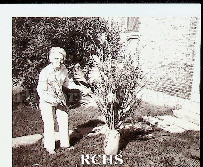 Black and white photograph of Ruth Hughes creating a floral arrangement.