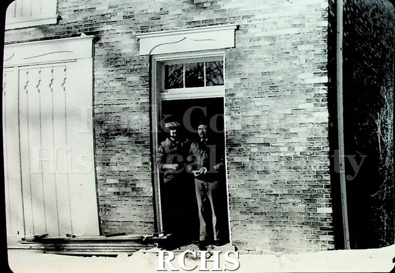 Black and white photograph of Brad Vincent and Art Levzow standing in the doorway of the carriage house.