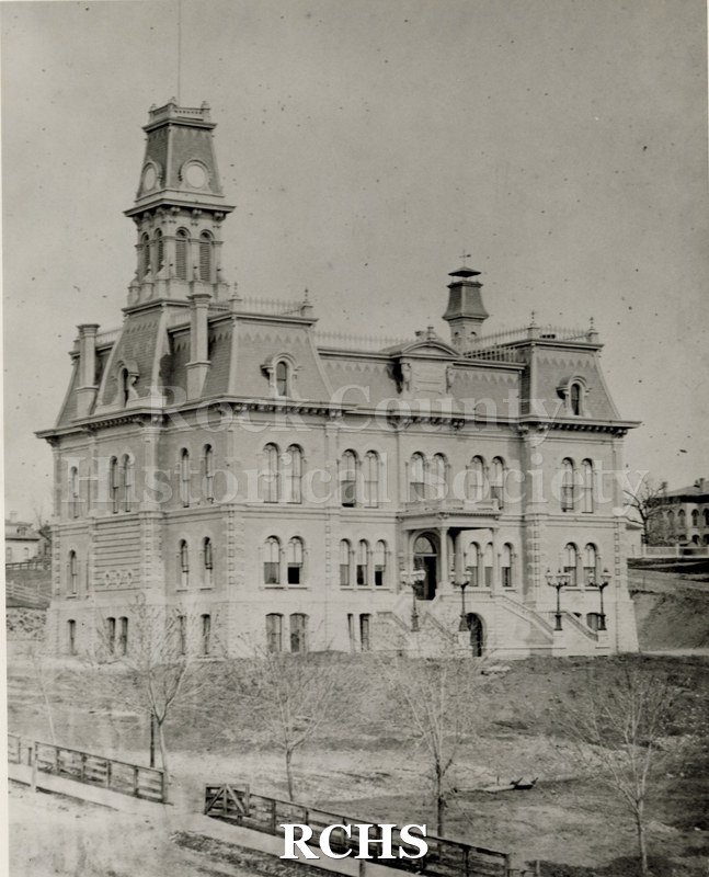 Black and white photograph of the Rock County Court House. Shows the three story building with bell tower. Original Photograph.