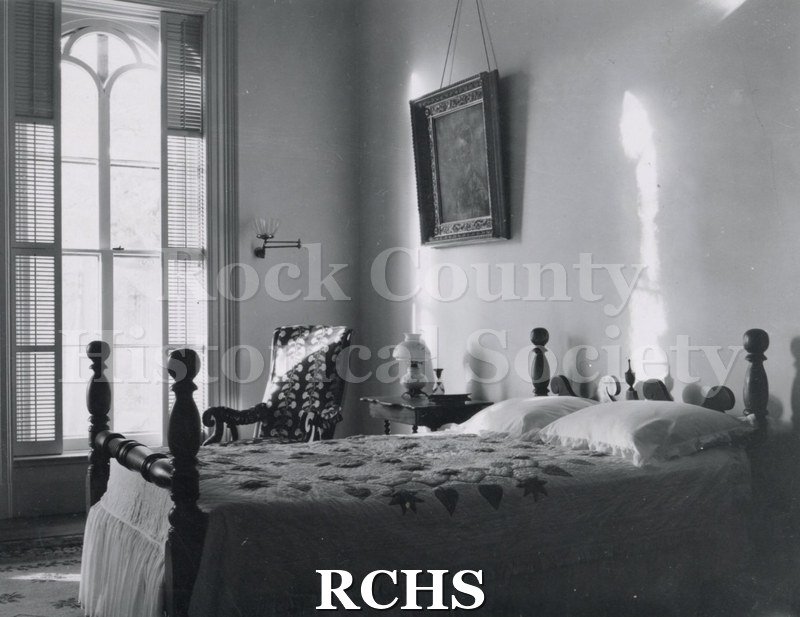 Black and white photograph of a bedroom in the Tallman House.