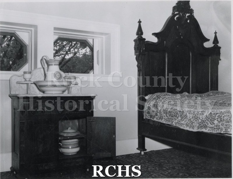 Black and white photograph of a bedroom in the Tallman House.