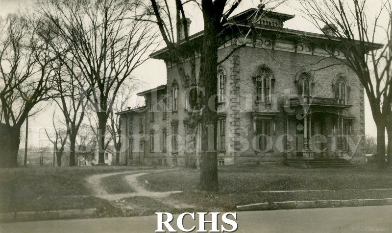 Black and white photograph of the Tallman House from left side. Several bare trees are in the picture.