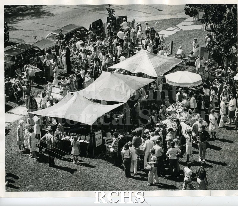 Black and white photograph of the 1974 Arts & Crafts Fair pictured from above. Shows tents with exhibits and the people standing around them.