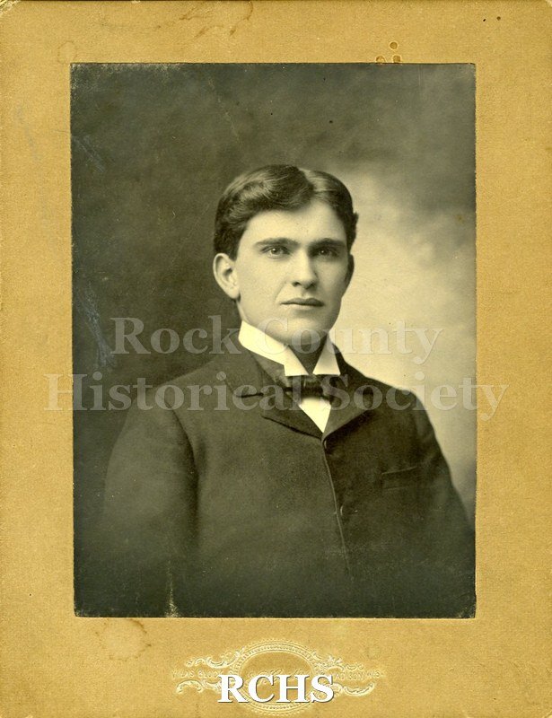 Black and white photograph of Wallace F. McGregor. Shows a young man wearing a dark suit jacket, white shirt and bow tie.