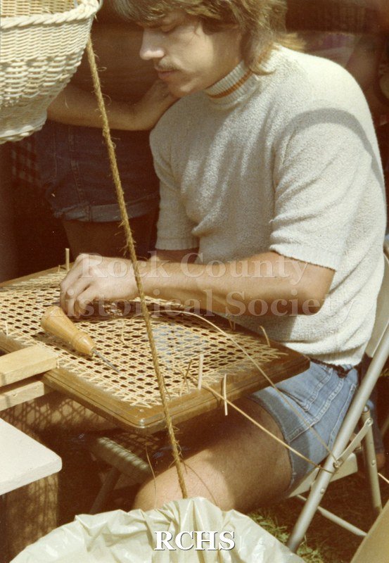 Color photo of Don Johanning caning a chair.