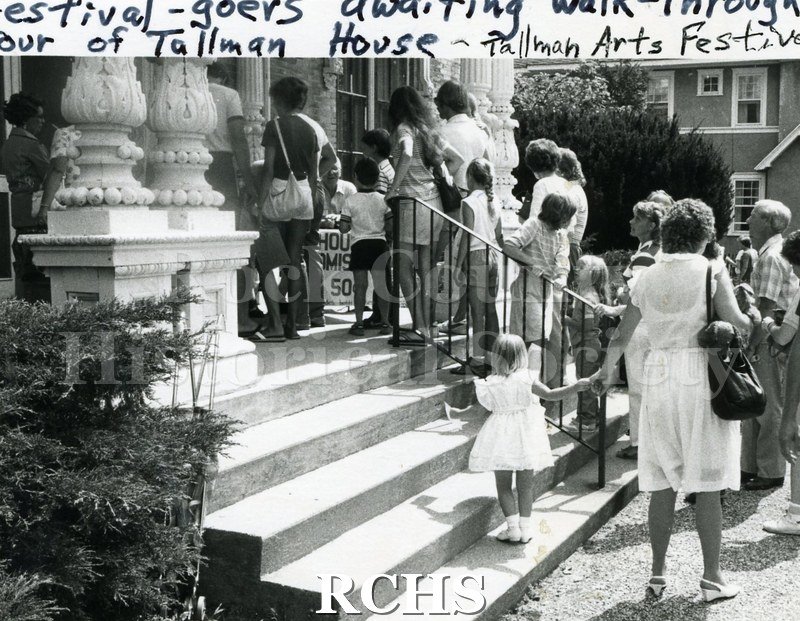 Black and white photograph of the 1984 Tallman Festival. Shows people standing on the steps of the Tallman House.