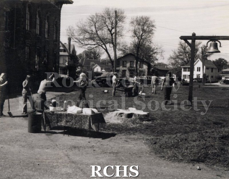 Black and white photograph of several high school boys working on the grounds of the Tallman Restorations.