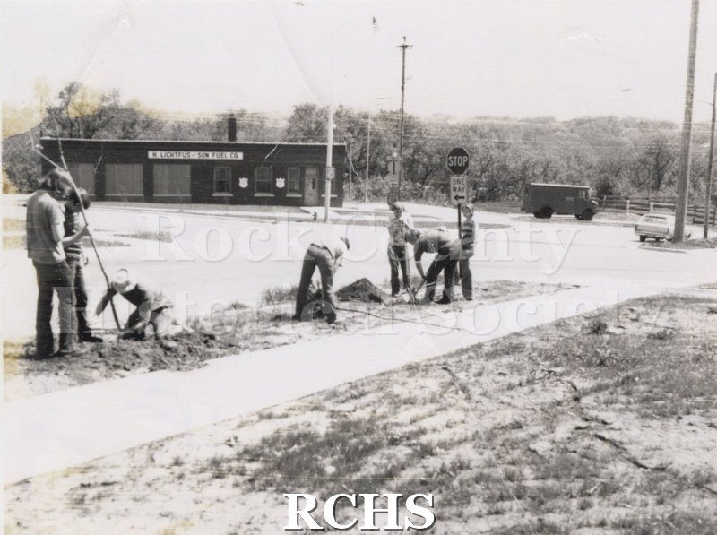 Black and white photograph of several high school boys working on the grounds of the Tallman Restorations.
