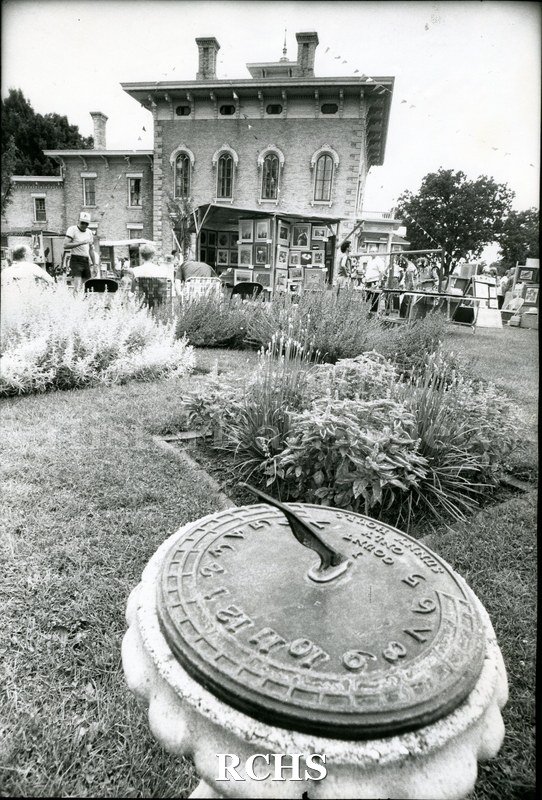 Historic image of 1983 Tallman Festival. Shows the art exhibit with the Tallman House in the background and the sun dial in the front.
