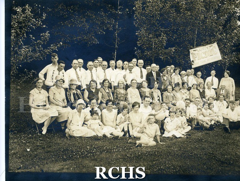 Black and white photograph of the Janesville Council #108 Picnic. Shows a group of men and women sitting and standing on a lawn.