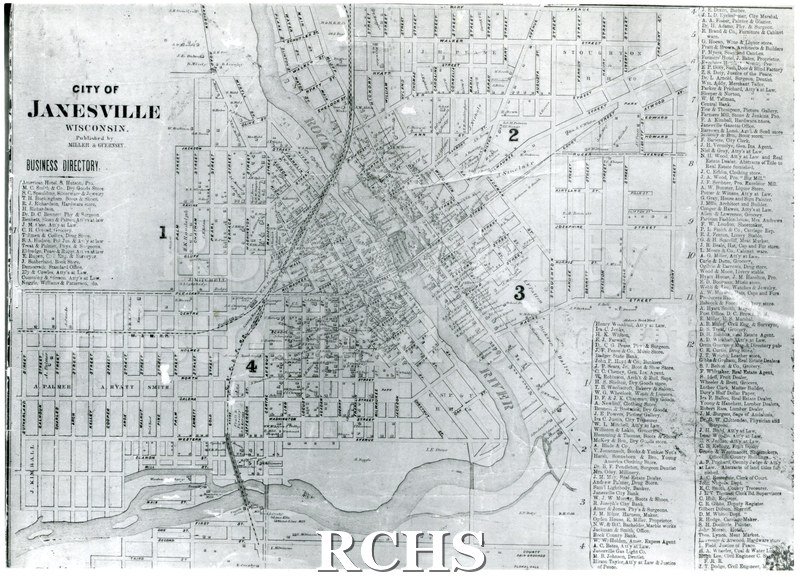 Black and white photograph of a drawing of a map of City of Janesville, WI, with streets and a business directory.