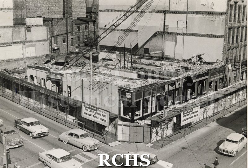 Black and white photograph of Myers Hotel Demolition. Shows a crane inside the building with debris scattered about. Second and third floors are gone.