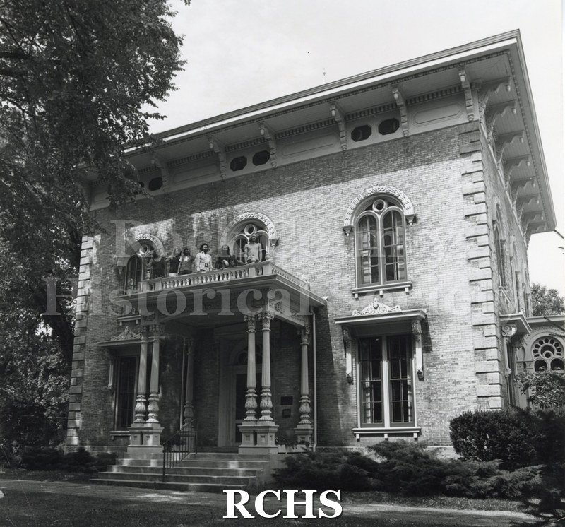 Black and white photograph of Orfordville Dump Truckers-Rock Group. Shows a band standing on the balcony of the Tallman House.