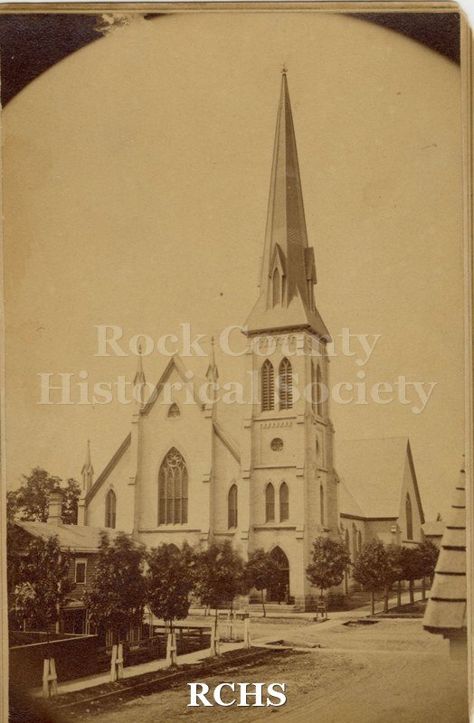 Sepia photo of First Congregational Church, Janesville, WI. Shows trees in a line beside the church.