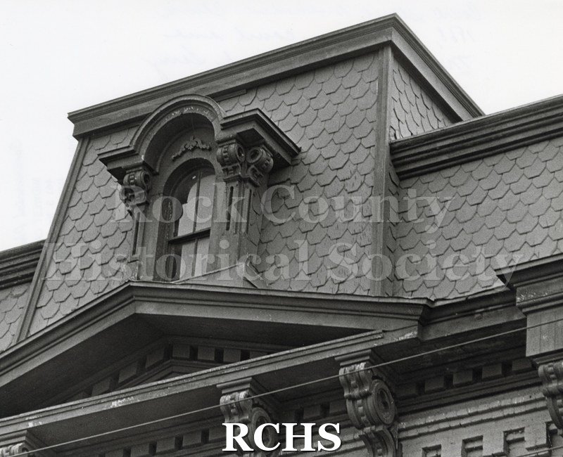 Black and white photograph of the Court Street Methodist Church. Shows the outside of a building showing the top story with an arched window.