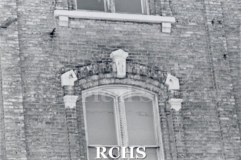 Black and white photograph of Myers Block-Old Armory, Janesville, WI, exterior view, showing double arched windows.