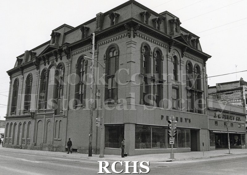 Black and white photograph of Court Street Methodist Church with Penney's Facade. Shows a four story building with arched windows.