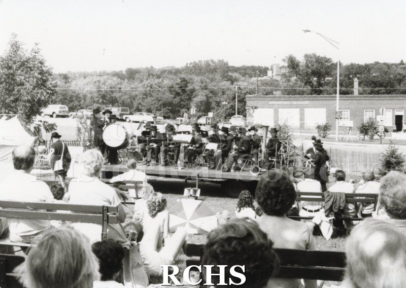 Black and white photograph of the Tallman Art Festival 1981. A Civil War era band is playing for an audience.