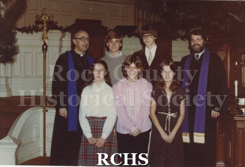 Color photo of the Faith Formation Class of 1981. Shows two boys and three girls standing in the nave of the church.