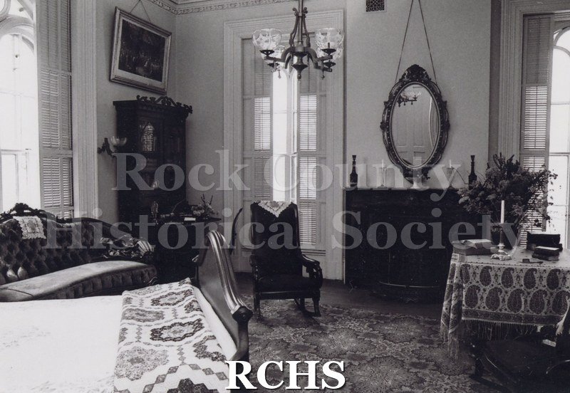 Black and white photograph of the Tallman House. Shows interior of a bedroom on the upper level of the Tallman House.