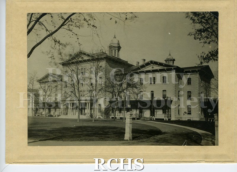 Black and white photograph of the Wis. State School for Visually Handicapped, Janesville, WI, a large three story building with a cupola on top and extensions on.