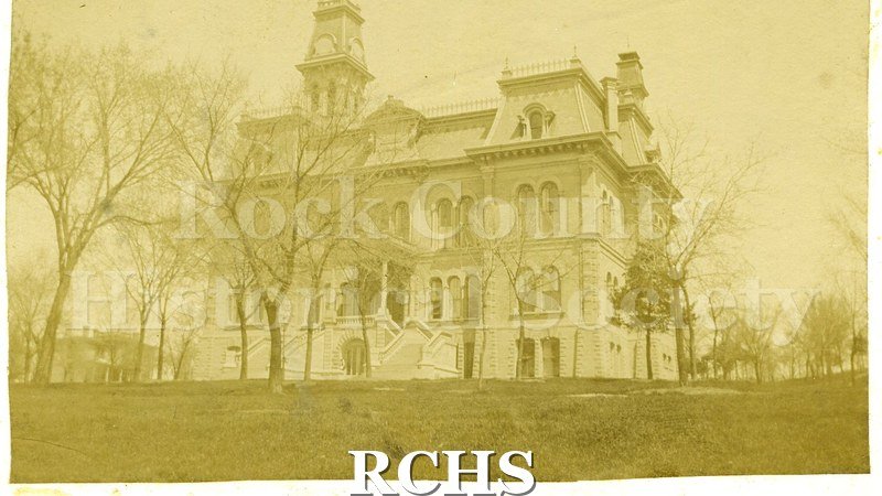 Historic image of Court House. Shows an historic three-story building with a clock tower on top.
