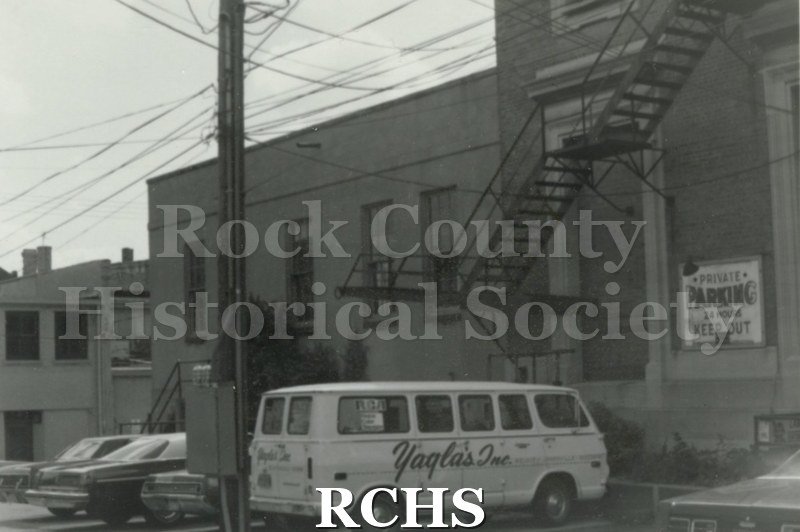 Black and white photograph of of the back of a building.