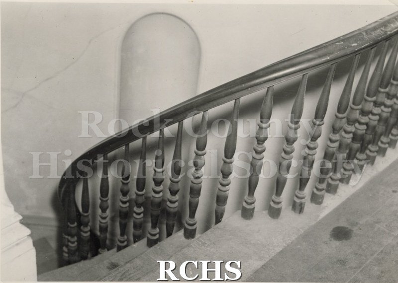 Black and white photograph of the stairway in the Tallman House showing the railing.