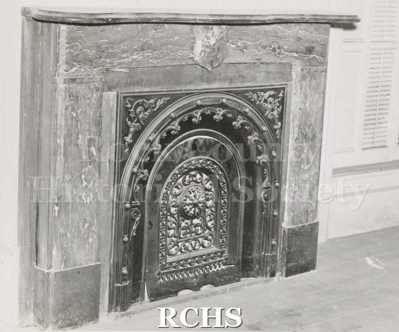 Black and white photograph of the Tallman House Lincoln bedroom fireplace with an ornate front.