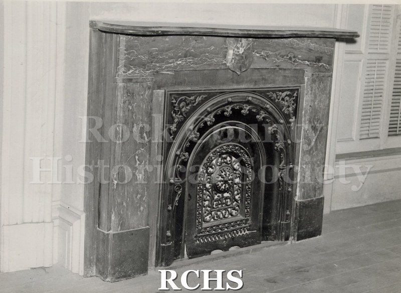 Black and white photograph of the Tallman House Lincoln bedroom fireplace with an ornate front.