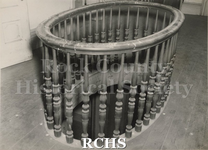 Black and white photograph of the mahogany balustrade around the oval opening in the Tallman House.