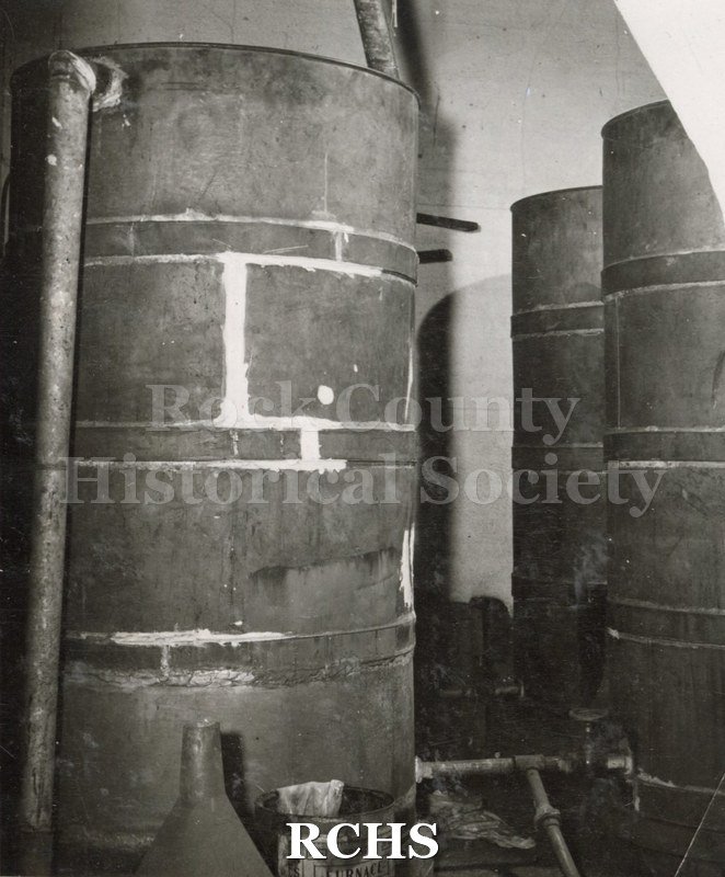 Black and white photograph of the water tanks in attic of Tallman House.