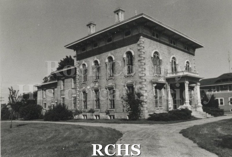 Black and white photograph of the Tallman House from the front and south side. Shows the driveway.