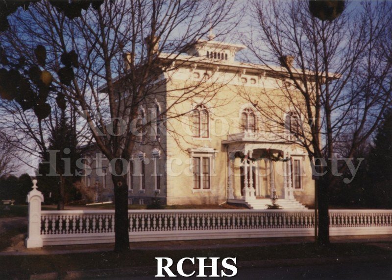 Historic image of Colorphotograph of the Tallman House from the front. Shows the fence in front.