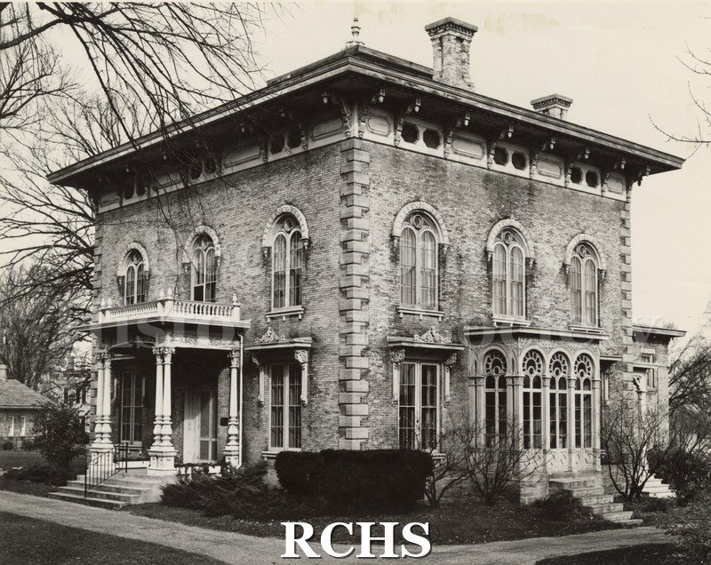 Black and white photograph of the Tallman House from the front and south side. Shows the driveway.