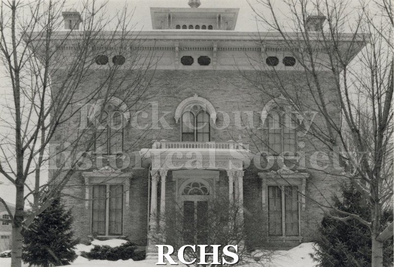Black and white photograph of the front of the Tallman House with snow on the ground.