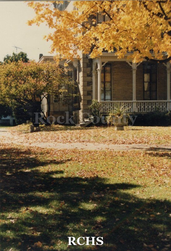 Color photo of the Tallman House porch in the fall.
