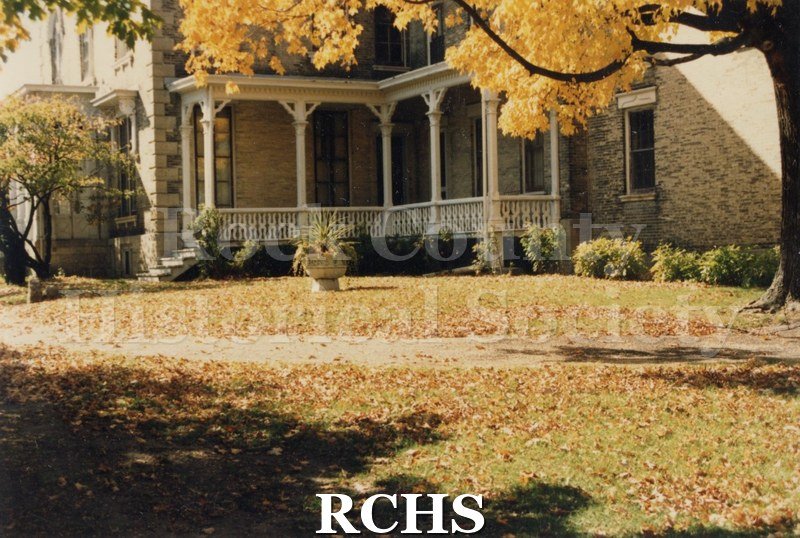 Color photo of the Tallman House porch in the fall.