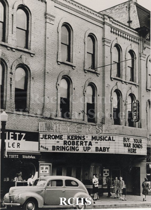 Historic image of Black and white copy print of the Myers Theater with a marque featuring Jerome Kerns' Musical "Roberta" also Bringing Up Baby.