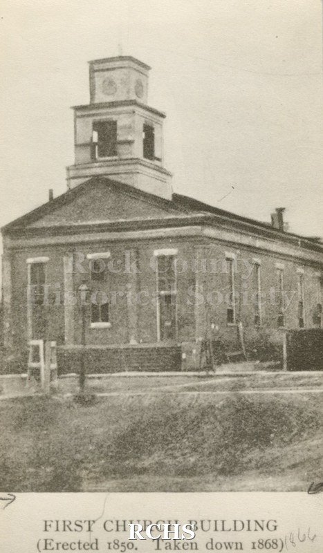 Black and white photograph of the First Congregational Church, Janesville, WI. On bottom: "First Church Building (Erected 1850.Taken down 1866)".